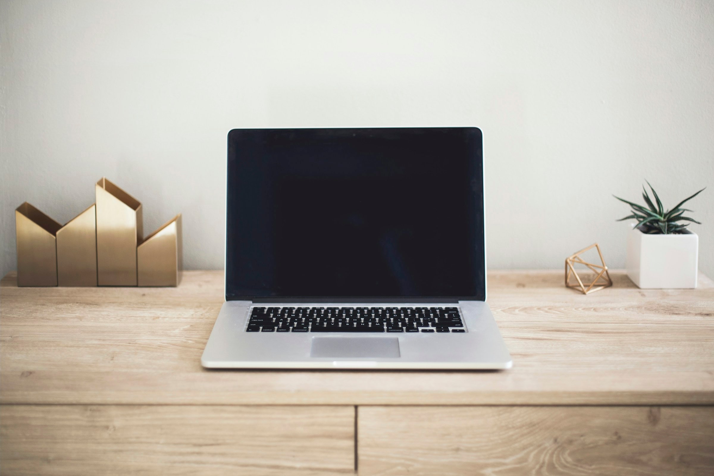 Laptop on a clean desk — moody warm light