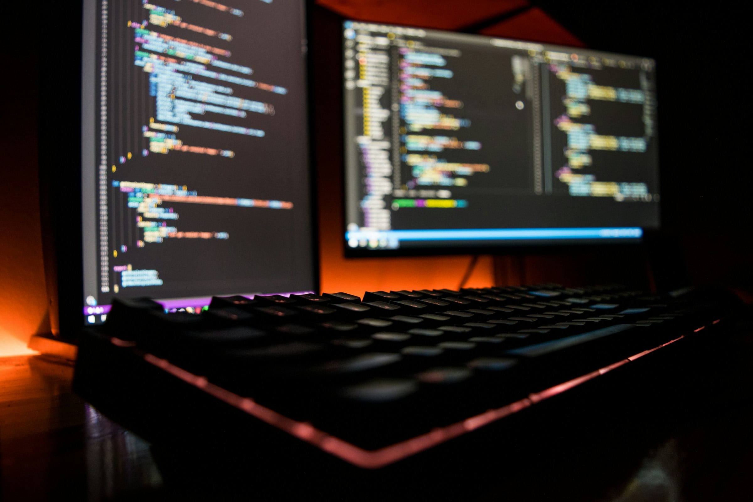 Hands typing on laptop — warm ambient light